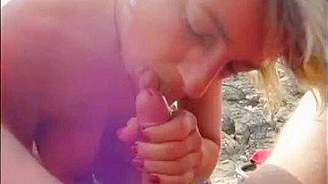 Nudist wife giving a blowjob to husband on public beach